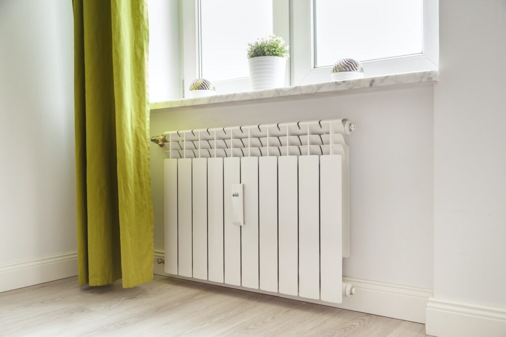 Heating white radiator radiator in living room.