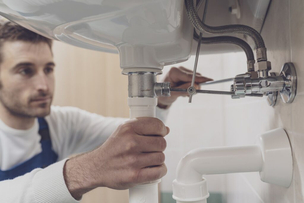 Plumber fixing a sink at home